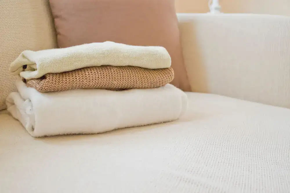 Heavyweight wool jumpers folded neatly