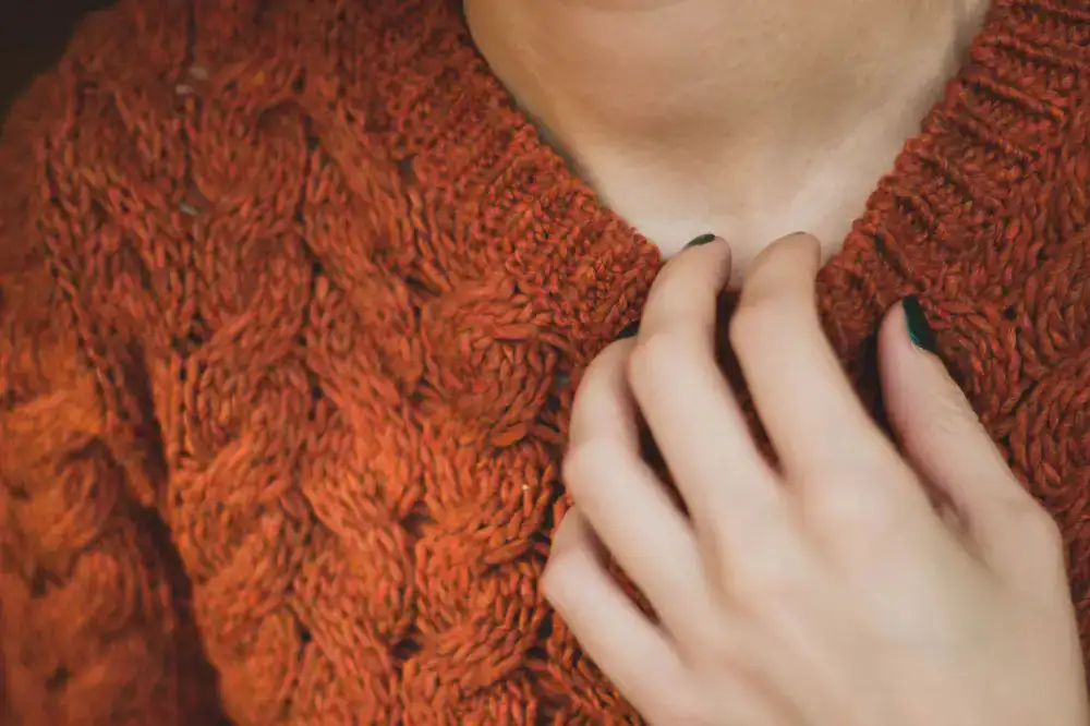 Close up showing the detailed stitch work on the collar of a wool sweater